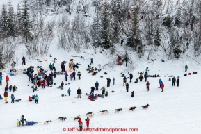 A team passes a tailgate party on the Chena River  after leaving the start line at Pike's Landing in Fairbanks on Monday March 9, 2015 during Iditarod 2015.(C) Jeff Schultz/SchultzPhoto.com - ALL RIGHTS RESERVED DUPLICATION  PROHIBITED  WITHOUT  PERMISSION