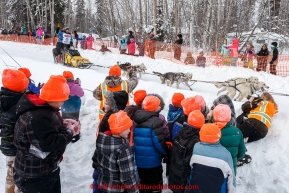 Seth Barnes passes by grade school kids out on field trip along Broadmoore street at Watershed school shortly after leaving the Fairbanks start line on Monday March 9 during the 2015 Iditarod.(C) Jeff Schultz/SchultzPhoto.com - ALL RIGHTS RESERVED DUPLICATION  PROHIBITED  WITHOUT  PERMISSION