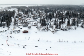 A team drops onto the Chena River after leaving the start line at Pike's Landing in Fairbanks on Monday March 9, 2015 during Iditarod 2015.(C) Jeff Schultz/SchultzPhoto.com - ALL RIGHTS RESERVED DUPLICATION  PROHIBITED  WITHOUT  PERMISSION