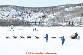 A team runs down the Tanana river and the Ice Classic tripod shorlty after leaving the first checkpoint at Nenana on March 9th, 2015 during the 2015 Iditarod.(C) Jeff Schultz/SchultzPhoto.com - ALL RIGHTS RESERVED DUPLICATION  PROHIBITED  WITHOUT  PERMISSION