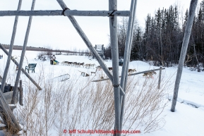 Brian Wilmshurt runs past a couple fish wheels on the banks of the Tanana River as he arrives at the first checkpoint of Nenana on March 9th, 2015 during the 2015 Iditarod.(C) Jeff Schultz/SchultzPhoto.com - ALL RIGHTS RESERVED DUPLICATION  PROHIBITED  WITHOUT  PERMISSION