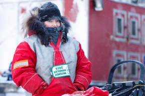 Tracey Schaeffer, Chuck Schaeffer's wife, waits at her husband's sled at the offical start of the 2015 Iditarod in Fairbanks, Alaska.(C) Jeff Schultz/SchultzPhoto.com - ALL RIGHTS RESERVED DUPLICATION  PROHIBITED  WITHOUT  PERMISSION