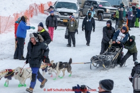 Rob Cooke holds on at the offical start of the 2015 Iditarod in Fairbanks, Alaska.(C) Jeff Schultz/SchultzPhoto.com - ALL RIGHTS RESERVED DUPLICATION  PROHIBITED  WITHOUT  PERMISSION