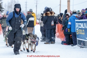 A dog handler keeps the dogs on the path to the start line of the offical start of the 2015 Iditarod in Fairbanks, Alaska.(C) Jeff Schultz/SchultzPhoto.com - ALL RIGHTS RESERVED DUPLICATION  PROHIBITED  WITHOUT  PERMISSION