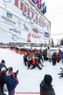 Holding back the pack at the offical start of the 2015 Iditarod in Fairbanks, Alaska.(C) Jeff Schultz/SchultzPhoto.com - ALL RIGHTS RESERVED DUPLICATION  PROHIBITED  WITHOUT  PERMISSION