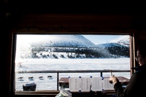 Iditarod volunteer keeps track of teams coming in and out of the Rainy Pass checkpoint.