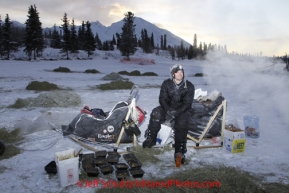 Tuesday March 6, 2012  Rookie Musher Matt Failor rests on his sled in the morning at the Rainy Pass checkpoint, Iditarod 2012.