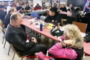 Wednesday March 7, 2012  Rick Swenson and DeeDee Jonrowe talk in the community center during their 24 hour layover at the Takotna checkpoint.   Iditarod 2012.