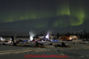 Friday March 9, 2012  Northern lights grace the sky over the    half-way checkpoint at Cripple while mushers tend to their dogs.   Iditarod 2012.