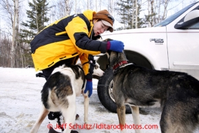 Volunteer veterinarian Carol Hedges of east Texas checks Charley Bejna's dog Poncho in Wasilla Wednesday, Feb. 27, 2013.