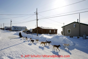 Ramey Smyth runs down the main road and into the Shaktoolik checkpoint on Monday March 11, 2013.Iditarod Sled Dog Race 2013Photo by Jeff Schultz copyright 2013 DO NOT REPRODUCE WITHOUT PERMISSION