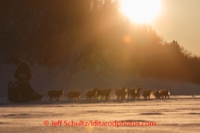 Richie Diehl runs down the Yukon river shortly after leaving the Ruby checkpoint at sunset on Friday, March 7, during the Iditarod Sled Dog Race 2014.PHOTO (c) BY JEFF SCHULTZ/IditarodPhotos.com -- REPRODUCTION PROHIBITED WITHOUT PERMISSION