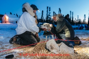 Kristi Berington talks with veterinarian Bill Sampson at the Cripple checkpoint, Friday March 7, during the Iditarod Sled Dog Race 2014.PHOTO (c) BY JEFF SCHULTZ/IditarodPhotos.com -- REPRODUCTION PROHIBITED WITHOUT PERMISSION