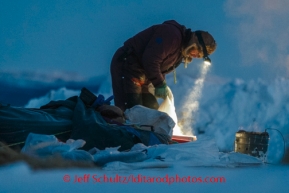 Bob Bundtzen makes dog food in Ruby on Saturday, March 8, during the Iditarod Sled Dog Race 2014.PHOTO (c) BY JEFF SCHULTZ/IditarodPhotos.com -- REPRODUCTION PROHIBITED WITHOUT PERMISSION