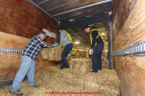 A team of volunteers bag over 1600 bales of straw at Airland Transport for use by the mushers and dogs at the 20+ checkpoints along the trail. Thursday February 12, 2015 prior to Iditarod 2015.(C) Jeff Schultz/SchultzPhoto.com - ALL RIGHTS RESERVEDDUPLICATION PROHIBITED WITHOUT PERMISSION