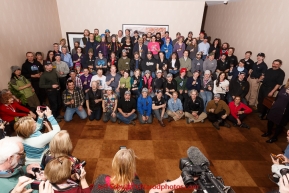 The entire field of 2015 Iditarod mushers pose for a group photo at the mandatory musher meeting on Thursday March 5, 2015 at the Millennium Hotel race headquarters in Anchorage.  Iditarod 2015 (C) Jeff Schultz/SchultzPhoto.com - ALL RIGHTS RESERVED DUPLICATION  PROHIBITED  WITHOUT  PERMISSION