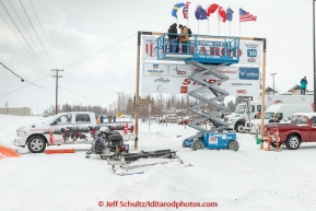 Volunteers set up the start banner outside Pike's Waterfront Lodge in Fairbanks on Sunday March 8, 2015 the day before the official start of Iditarod 2015(C) Jeff Schultz/SchultzPhoto.com - ALL RIGHTS RESERVED DUPLICATION  PROHIBITED  WITHOUT  PERMISSION
