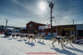 Lisbet Norris runs into the chute and across the finish line in Nome on Saturday March 21, 2015 during Iditarod 2015.  (C) Jeff Schultz/SchultzPhoto.com - ALL RIGHTS RESERVED DUPLICATION  PROHIBITED  WITHOUT  PERMISSION