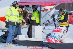 Volunteers help Volunteer Iditarod Air Force pilot, John Norris load his plane with musher drop bags, people food and HEET for a trip to the Rainy Pass checkpoint at the Willow, Alaska airport during the Food Flyout on Saturday, February 20, 2016.  Iditarod 2016