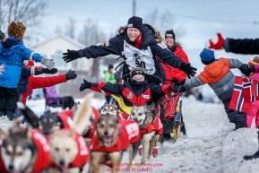 Ed Stielstra runs down Cordova Street giving high-fives to spectators during the Ceremonial Start of the 2016 Iditarod in Anchorage, Alaska.  March 05, 2016