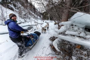 Ryne Olson on the trail in the Alaska Range in the Dalzell Gorge on the way to Rohn from the Rainy Pass checkpoint during Iditarod 2016.  Alaska.  March 07, 2016.  Photo by Jeff Schultz (C) 2016 ALL RIGHTS RESERVED