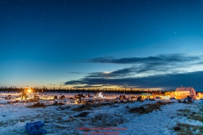 Teams rest as the musher feed and fix sleds at the Cripple checkpoint at dusk on Thursday March 10 during Iditarod 2016.  Alaska.    Photo by Jeff Schultz (C) 2016  ALL RIGHTS RESERVED