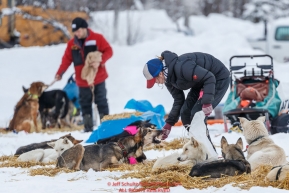 Emily Maxwell feeding her team in McGrath, Alaska during the 2019 Iditarod on Wednesday, March 6th 2019.Photo by Jeff Schultz/  (C) 2019  ALL RIGHTS RESERVED