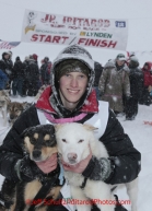 Junior Iditarod champion Conway Seavey (a 3rd generation Seavey dog musher) poses with his lead dogs Memphis (left) and Sarge at the finish line after winning the 2012 Junior Iditarod.