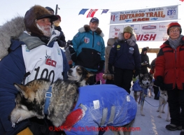 Sunday March 18, 2012    Dan Seavey, mushing to celebrate the 100th anniversary of the National Historic Iditarod Trail with his lead dogs at the finish line in Nome. Iditarod 2012.