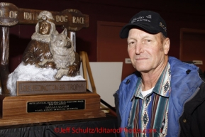 Sunday March 18, 2012   Honorary musher Dave Olson next the Joe Redington Sr. award at the musher's finisher banquet in Nome after Iditarod 2012.