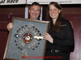 Sunday March 18, 2012  Aliy Zirkle recieves the PenAir Spirit of Alaska award from Danny Seybert at the musher's finisher banquet in Nome after Iditarod 2012.