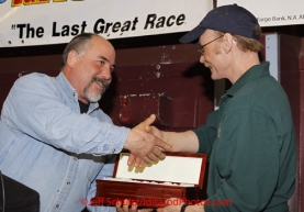 Sunday March 18, 2012   Mitch Seavey recieves the 1st musher to the Yukon award from fellow musher Scott Janssen at the musher's finisher banquet in Nome after Iditarod 2012.