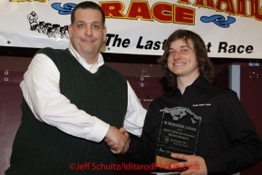 Sunday March 18, 2012   Rohn Busser recieves the Horizon Lines Most Improved musher award at the musher's finisher banquet in Nome after Iditarod 2012.