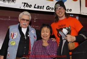 Sunday March 18, 2012   Brent Sass recieves the Jerry Austin memorial Rookie of the Year award from Clara Austin and Bill Crawford at the musher's finisher banquet in Nome after Iditarod 2012.