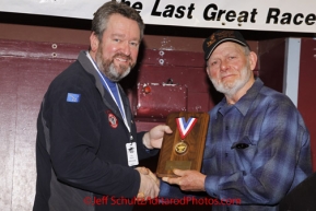 Sunday March 18, 2012   Dan Seavey recieves the ExxonMobil Musher's choice award from Bill Brackin at the musher's finisher banquet in Nome after Iditarod 2012.