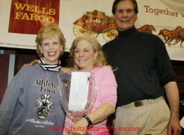 Sunday March 18, 2012  DeeDee Jonrowe recieves the Alaska Airlines Leonhard Seppala Humanitarian award from Marilyn Romano of Alaska Airlines (L) and chief veterinarian Stu Nelson at the musher's finisher banquet in Nome after Iditarod 2012.