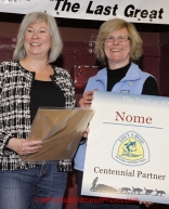 Sunday March 18, 2012  Iditarod National Historic Trail Alliance president Judy Bittner (R) presents a Centennnial Partner commendation to Nome Mayor Denise Michaels at the musher's finisher banquet in Nome after Iditarod 2012.