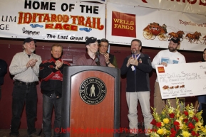 Sunday March 18, 2012   2012 Iditarod Champion Dallas Seavey speaks to the audience at the musher's finisher banquet in Nome with the 4 presenting sponsors behind him.