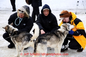 Carol Hedges, right, checks Charley Bejna's dog, center, during mandatory vet checks in Wasilla Wednesday, Feb. 27, 2013.