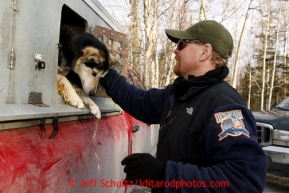 Dog handler Clint Warnke removes one of Bob Bundtzen's dogs for volunteer veterinarians to check in Wasilla Wednesday, Feb. 27, 2013.