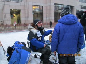 Martin Buser demonstrating a light weight swivel chair he has installed to the rear of his sled