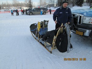 martin buser with his sled in the parking lot at 10am