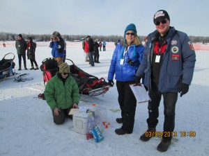 Dr. Morrie Craig and testing crew collect urine sample in dog yard