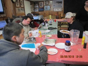 mushers on a 24 discuss the time sheet., Mike williams jr foreground Cym and Rayme back left and Jessica Royer back right