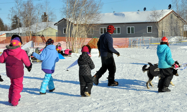 Martin Buser on a walk with his dogs and some kids