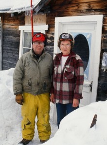 Volunteer checkers Dick and Audra Forsgren pose for a photo outside their cabin at the Ophir checkpoint during the 1991 Iditarod